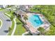 Aerial view of a community pool with a covered seating area, lounge chairs, and lush landscaping at 11038 Leafshore Loop, Orlando, FL 32829