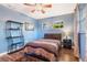 Stylish bedroom with blue walls, a ceiling fan, and wood-look flooring at 115 Shepherd Trl, Longwood, FL 32750