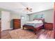 Charming bedroom featuring wood flooring, a ceiling fan, and natural light at 115 Shepherd Trl, Longwood, FL 32750