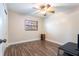 Clean and simple bedroom with wood-look flooring and a ceiling fan at 115 Shepherd Trl, Longwood, FL 32750