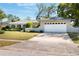 Exterior showcasing the front of a home with a two-car garage and a well-kept front lawn at 115 Shepherd Trl, Longwood, FL 32750