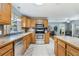 Bright kitchen featuring stainless steel appliances, oak cabinets and views to the living room at 115 Shepherd Trl, Longwood, FL 32750