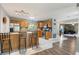 Kitchen featuring oak cabinets, stainless steel appliances, and an adjacent view of the living room at 115 Shepherd Trl, Longwood, FL 32750