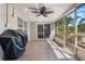 Relaxing screened-in patio with tile flooring and outdoor seating at 115 Shepherd Trl, Longwood, FL 32750