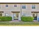 Charming townhome featuring a private brick-paved patio area with sliding glass door and landscaped greenery at 1298 Royal St George Blvd, Davenport, FL 33896