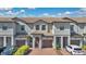 Charming townhome featuring a tile roof, private garages, and well-maintained landscaping at 1298 Royal St George Blvd, Davenport, FL 33896