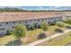 Aerial view of townhomes, showcasing well-maintained exteriors, landscaping, and a sidewalk at 1298 Royal St George Blvd, Davenport, FL 33896