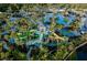 Expansive aerial view of a water park with multiple pools, slides, and cabanas, offering diverse recreational amenities at 14501 Grove Resort Ave # 1229, Winter Garden, FL 34787