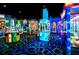 This arcade features an array of games for Gathering fun with colorful decor and lighting at 14501 Grove Resort Ave # 1229, Winter Garden, FL 34787