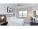 Contemporary bedroom featuring a large window with scenic views and comfortable accommodations at 14501 Grove Resort Ave # 1229, Winter Garden, FL 34787