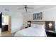 Comfortable bedroom featuring a ceiling fan, stylish decor, and an ensuite bathroom at 14501 Grove Resort Ave # 1229, Winter Garden, FL 34787