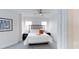 Comfortable bedroom with a plush bed, bedside tables, lamps, and a decorative piece of artwork at 14501 Grove Resort Ave # 1229, Winter Garden, FL 34787