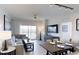Cozy living and dining area with contemporary furnishings, a ceiling fan, and natural light from the balcony at 14501 Grove Resort Ave # 1229, Winter Garden, FL 34787