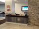 This lobby features tile floors, a dark wood reception desk, and a stone-accent wall at 14501 Grove Resort Ave # 1229, Winter Garden, FL 34787