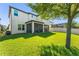 Scenic backyard featuring lush lawn and view of the home's screened porch at 14661 Glade Hill Park Way, Winter Garden, FL 34787