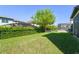 Beautiful backyard with green lawn, partial fencing, and screened-in pool enclosure in view at 14661 Glade Hill Park Way, Winter Garden, FL 34787