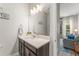 Well-lit bathroom with modern vanity and an open view to a living space at 14661 Glade Hill Park Way, Winter Garden, FL 34787