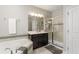 Well-lit bathroom featuring a soaking tub, vanity with cabinets, and a glass-enclosed shower with a tile surround at 14661 Glade Hill Park Way, Winter Garden, FL 34787