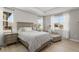 Serene bedroom boasts natural light, a cozy chaise lounge, and neutral tones for a restful retreat at 14661 Glade Hill Park Way, Winter Garden, FL 34787