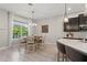 Bright dining area with wood floors, stylish light fixture, and a large window for natural light at 14661 Glade Hill Park Way, Winter Garden, FL 34787