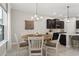 Dining area features wood floors, stylish light fixture, decor and a large window for natural light at 14661 Glade Hill Park Way, Winter Garden, FL 34787