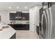 Contemporary kitchen featuring dark cabinets, stainless steel appliances, and a countertop island, offering ample space at 14661 Glade Hill Park Way, Winter Garden, FL 34787