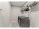 Efficient laundry room featuring modern, front-load washer and dryer, tile flooring, and shelving for storage at 14661 Glade Hill Park Way, Winter Garden, FL 34787