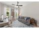 Cozy living room with bright windows, a ceiling fan, and comfortable seating at 14661 Glade Hill Park Way, Winter Garden, FL 34787