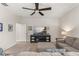 Bright living room featuring a large sectional sofa, media console, and a ceiling fan for added comfort at 14661 Glade Hill Park Way, Winter Garden, FL 34787