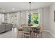 Cozy living room adjacent to the dining area, featuring natural light and neutral decor at 14661 Glade Hill Park Way, Winter Garden, FL 34787