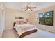 Comfortable bedroom with a ceiling fan, large window, and plush carpet at 1912 Abbington St # Ge, Apopka, FL 32712