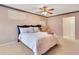 Comfortable bedroom with a ceiling fan, soft carpet, and calm, inviting decor at 1912 Abbington St # Ge, Apopka, FL 32712