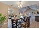 Dining area featuring stylish chandelier and seating for four, with easy access to living room at 1912 Abbington St # Ge, Apopka, FL 32712