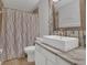 Clean bathroom with a vessel sink, granite countertop, decorative mirror, and shower curtain at 1923 Osman Ave, Orlando, FL 32806