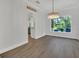 Bright dining room with gray wood floors, white walls and trim, and modern chandelier at 1923 Osman Ave, Orlando, FL 32806