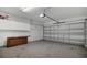 Well-lit garage with cabinets, utility sink and a large door leading to the driveway at 1923 Osman Ave, Orlando, FL 32806