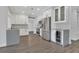 Modern kitchen featuring white cabinets, stainless steel appliances, and gray countertops at 1923 Osman Ave, Orlando, FL 32806