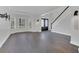 Bright living room with gray wood floors, white walls and trim, and a staircase at 1923 Osman Ave, Orlando, FL 32806