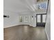 Bright living room with gray wood floors, white walls and trim, and a staircase at 1923 Osman Ave, Orlando, FL 32806