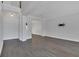 Bright living room with gray wood floors, white walls and trim, and modern sconce lighting at 1923 Osman Ave, Orlando, FL 32806