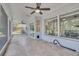 Enclosed sunroom with ceiling fans and views of the lush backyard landscaping at 1923 Osman Ave, Orlando, FL 32806
