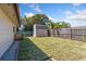 Fenced backyard with shed, grass, and tropical trees at 1925 Poinsetta Ln, Maitland, FL 32751