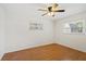 Well-lit bedroom features a ceiling fan and two windows at 1925 Poinsetta Ln, Maitland, FL 32751