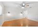 Bedroom offers ceiling fan, wood floors, and stylish sconce lighting at 1925 Poinsetta Ln, Maitland, FL 32751