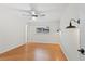 Inviting bedroom with ceiling fan, wood floors and sconce lighting at 1925 Poinsetta Ln, Maitland, FL 32751