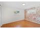 Cozy bedroom featuring brick accent wall and plenty of natural light at 1925 Poinsetta Ln, Maitland, FL 32751