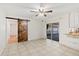 Dining area featuring modern ceiling fan, sliding glass doors, and stylish barn door at 1925 Poinsetta Ln, Maitland, FL 32751