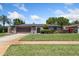 Home with stone veneer, mature landscaping and well-maintained lawn at 1925 Poinsetta Ln, Maitland, FL 32751