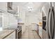 Well-lit kitchen featuring stainless steel appliances, granite countertops, and ample cabinet space at 1925 Poinsetta Ln, Maitland, FL 32751