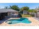 Backyard view of private pool, patio, and fenced yard with grass and shed at 1925 Poinsetta Ln, Maitland, FL 32751